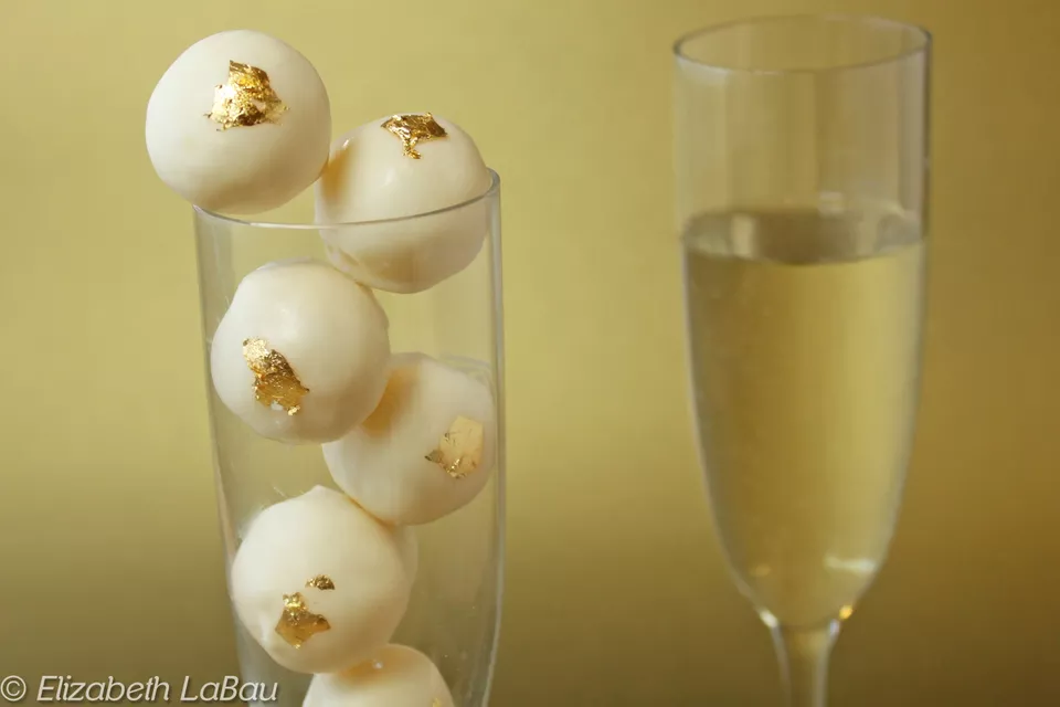 Champagne white chocolate truffles decorated with edible gold leaf