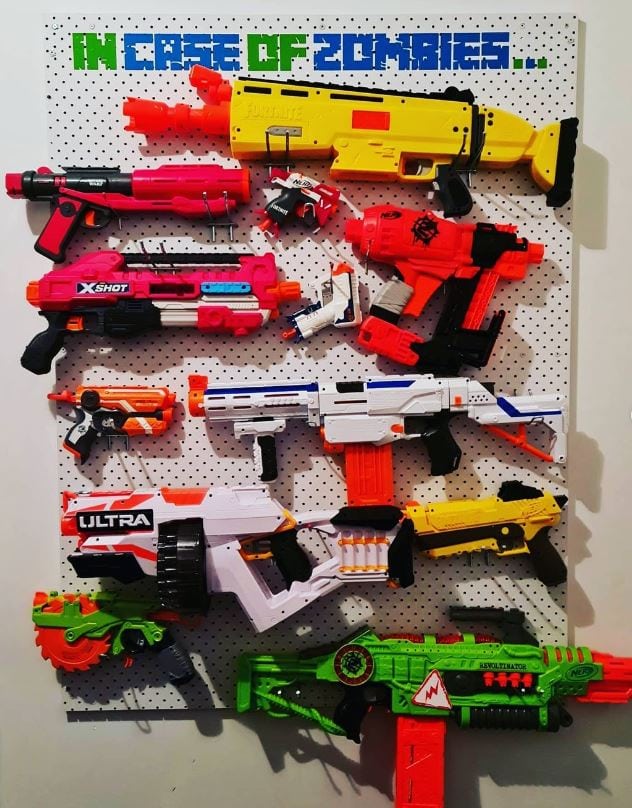 Pegboard on wall with nerf guns stored