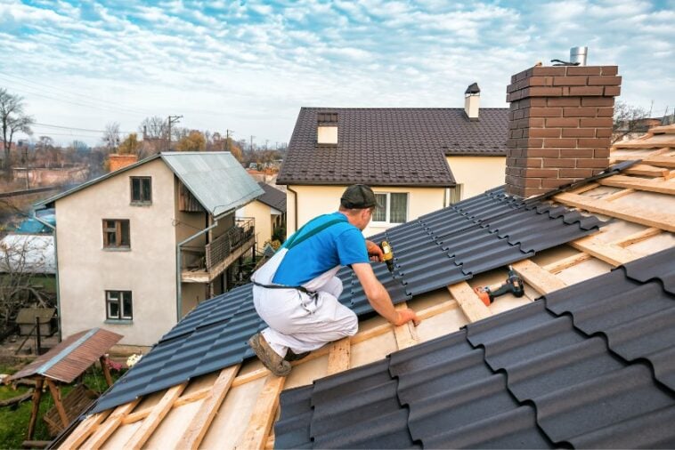 guy installing sheet panel roof